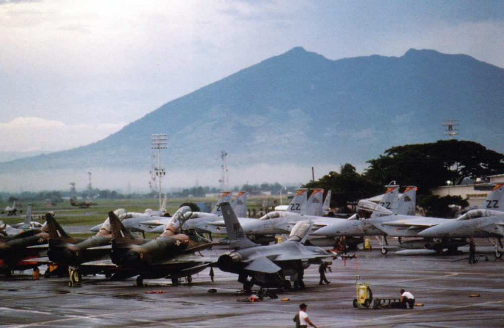 75 Sqn Skyhawks sharing the Ex Cope Thunder flightline with USAF F15 and F16 aircraft. Mt Pinatubo volcano is in the background – US DoD photo in ‘Skyhawks’, pg 114
