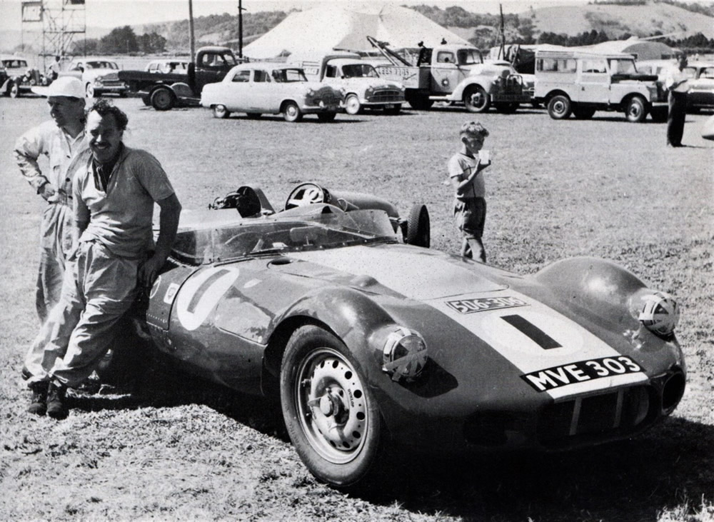 Ardmore 11 Jan 58 – on the left, leaning on driver’s door, is Archie Scott-Brown with his ‘work’s Lister-Jaguar MVE 303 – photo Dick Barton in’ Powered by Jaguar’ by Doug Nye, page 103