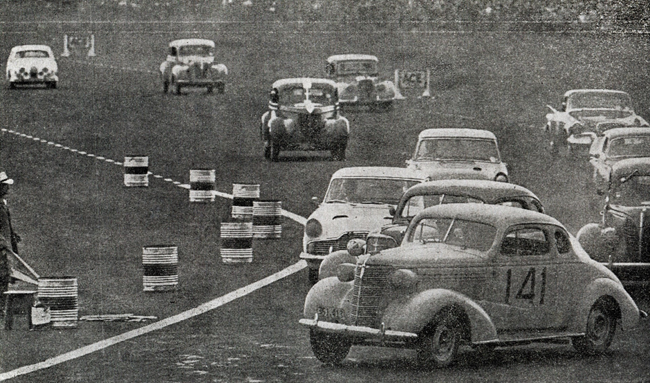 Ardmore 6 Jan 62 – Event 8 Saloon Car Scratch race - #141 G. Dixon Chev Coupe. The third car back on the right margin is #149 A. McLeod Jaguar Mk1 3.8. In the left rear of the photo, the white car is #148 J. Mackintosh Jaguar 2.4 ‘Mk 1’ – photo 8 O’Clock 6 Jan 62