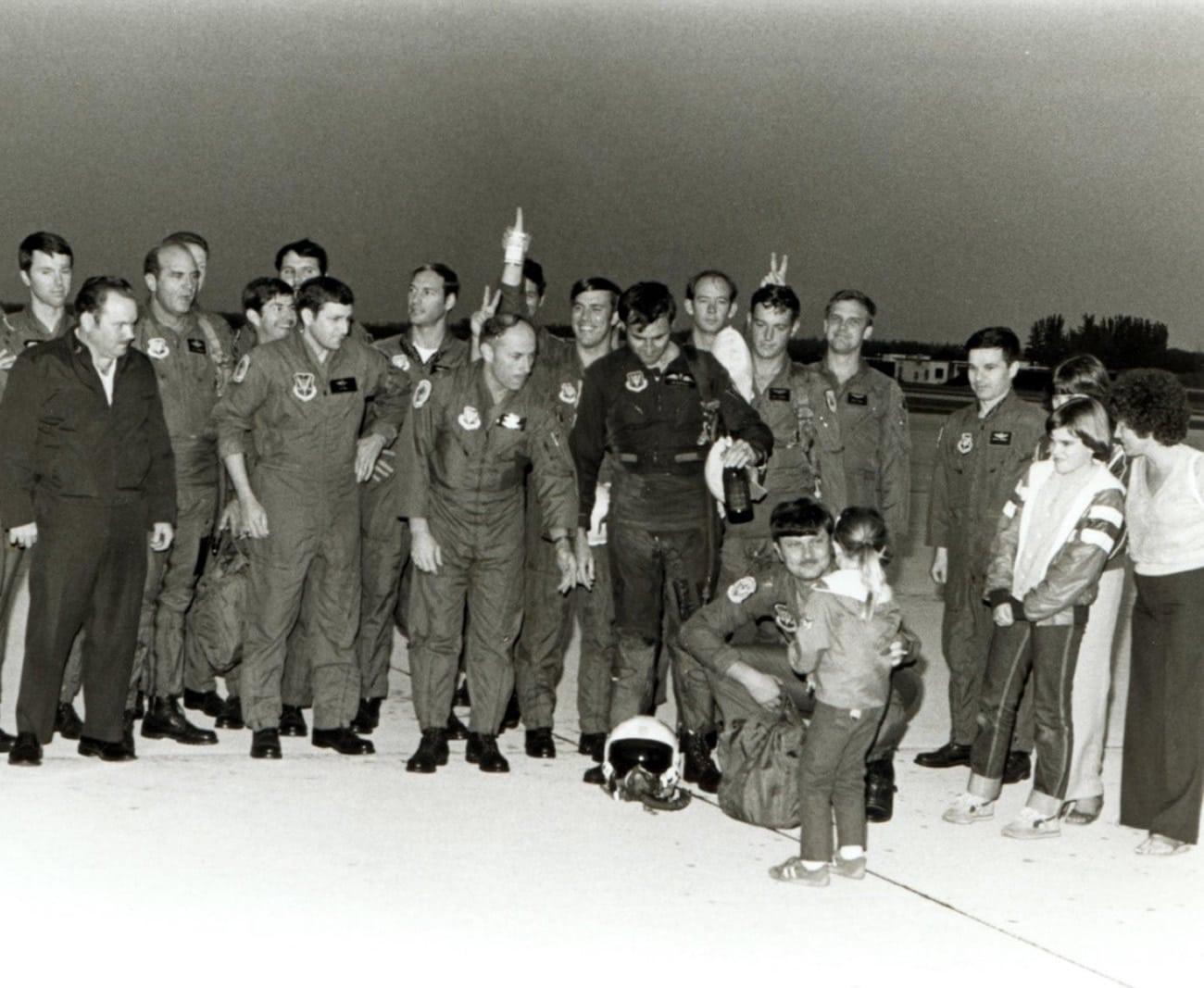 A doused Sqn Ldr Jim Barclay with ‘champers’ bottle and Joanie Barclay on right, daughters Nicola, Tracey and Steph (in lower front) and 308th TFTS aircrew after Jim’s final F4 flight, Homestead AFB, Florida 26th January 1982