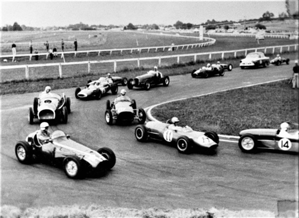 Pukekohe 22 Feb 64 - #14 Peter Slocombe Lotus 18 Ford 1340cc, #11 Bryan Thomas Gemini Mk3A Ford 1340cc, #4 Brian Rice Cooper T23 Holden, inside and behind #11 is #10 Jamie Aislabie BMC Special and on the outside is #1 McCarten, #8 Bill Thomasen Cooper T53 Climax, #22 Roly Levis Lotus 22 Ford, #10 Ivan Cranch Maserati 6CM Jaguar, #5 Dene Hollier Cooper T52 Ford, #7 Ken Sager Lotus, driver unknown in Humber 80, #6 Dick Butters Cooper MkIX Norton