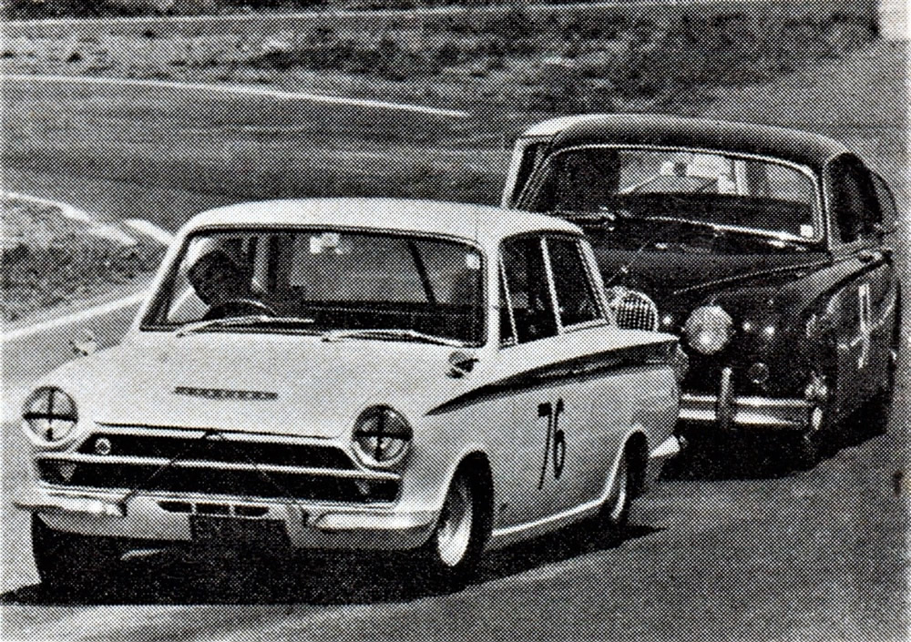 Pukekohe 25 Feb 67 - Trevor Pengelly #76 Lotus-Cortina leads Graham Hitch in the 1966 Wills 6-Hour winning #51 Jaguar Mk2 3.8. Hitch was to lose control on the last lap and severely damage the Jaguar – photo Motorman April 1967.