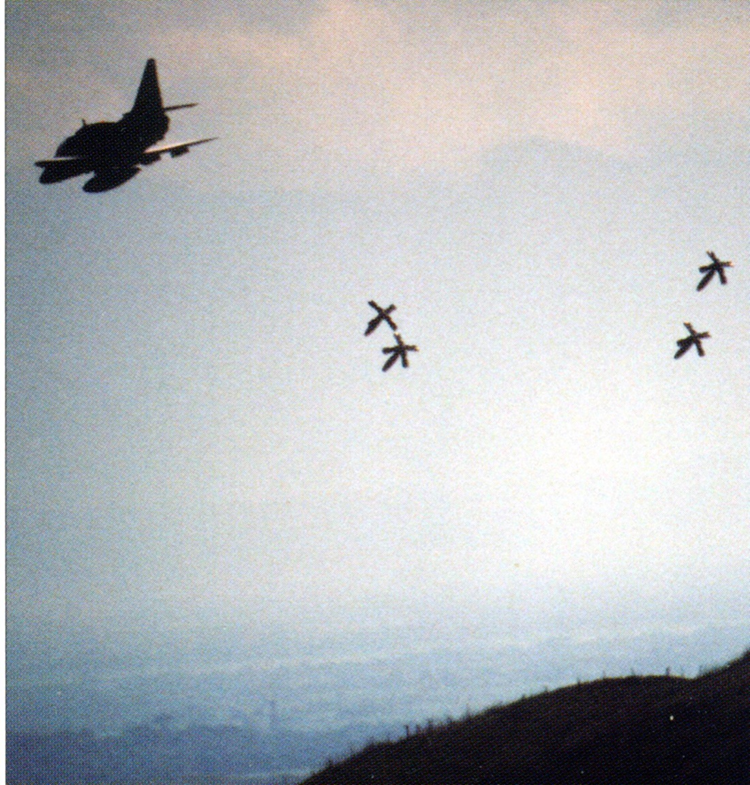 A 75 Sqn Skyhawk A4K at low level dropping four Mk82 500lb inert bombs fitted with ‘Snake-eye’ fins (extended) – Crow Valley weapons range, Philippines – US DoD photo in ‘Skyhawks’ page 116