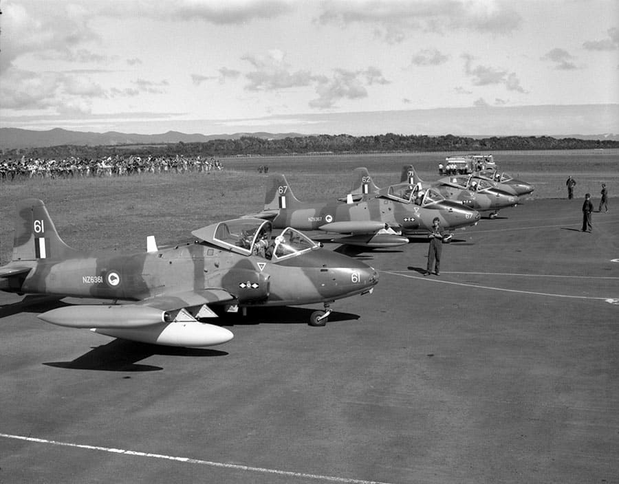 Ex Falcons Roost 17 Kaitaia – Open Day, Sunday 24 Apr 83 – Strikemasters NZ6361 (with white drop tanks), 67 (with ‘camo’ drop tanks), 62, and 71 on the airfield parking bay, with some of the big crowd beyond – photo RNZAF G798-83