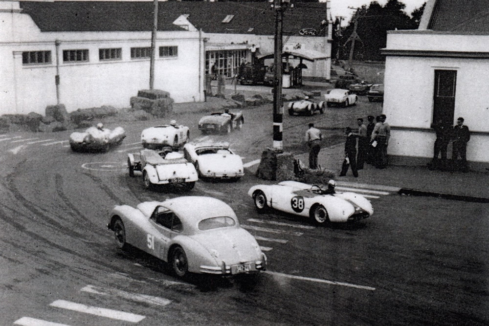 Waimate 11 Feb 61 – Sports Car race – Turn 1 from Queen Street into Victoria Crescent - #51 Bruce Monk Jaguar XK140 Coupe 3442cc, #38 Miss Ivy Stephenson Buckler 1098cc – photo Scott Thomson’s booklet ‘The Waimate 50: An Era Past’