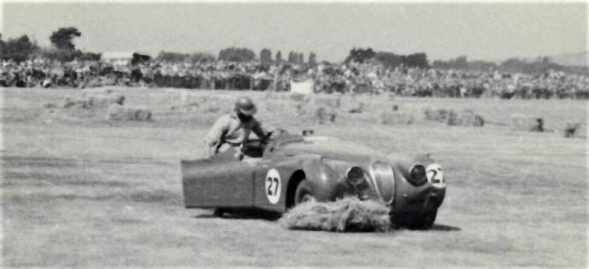 Wigram 6 Feb 54 - Ray Archibald #27 Jaguar XK120 suffered a blown tyre on the Pit Straight in the Lady Wigram Trophy race, which put him into the hay bales. Photo via Phil Benvin